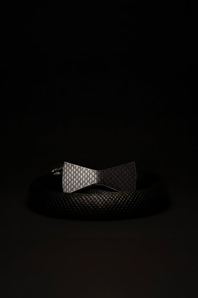 Black Mamba textured belt and bow tie on a black background