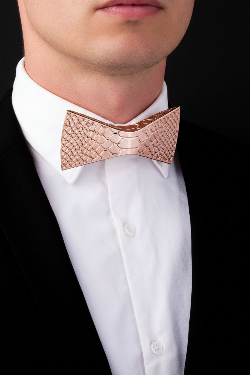 Rose gold bow tie on a white shirt against a black background
