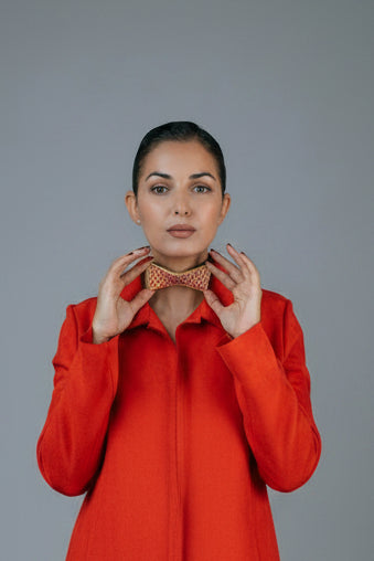 Woman wearing a bow tie against a gray background