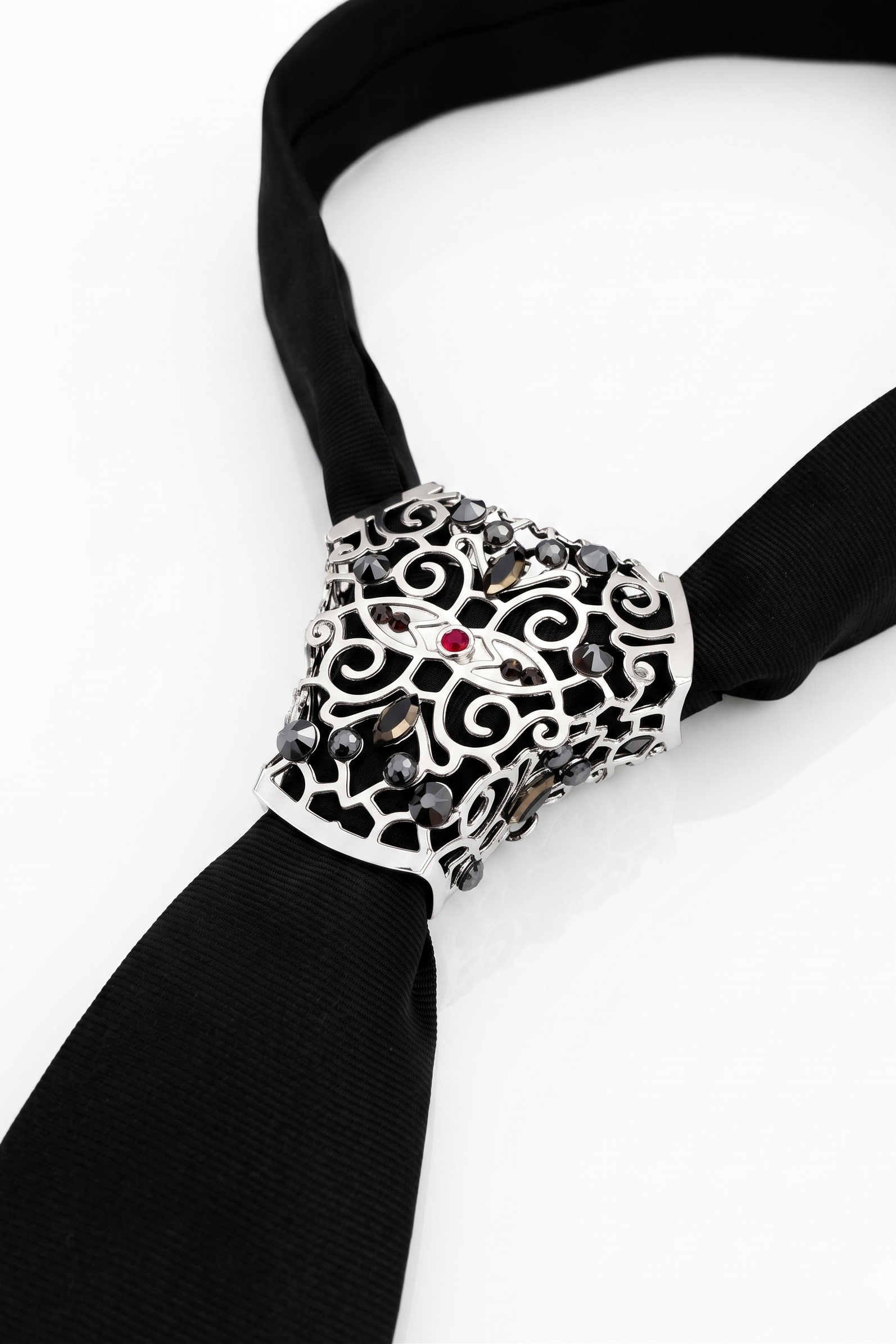 Decorative napkin holder with intricate design on a black napkin against a white background