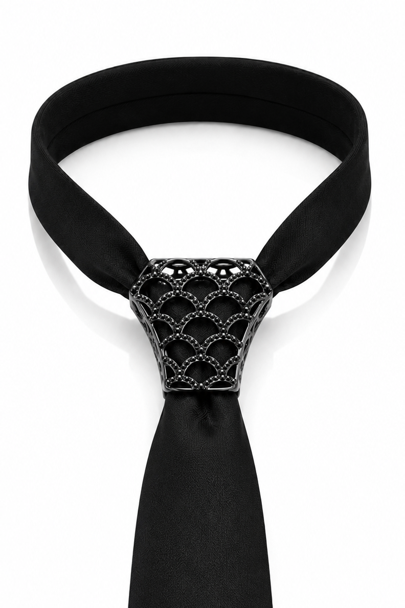 A black necktie with a distinctive textured, scale-like metallic connector at the knot, shown on a plain white background.