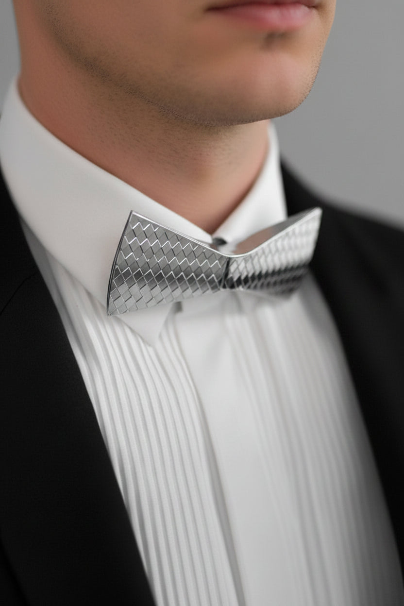 Gold bow tie on a white shirt against a black background
