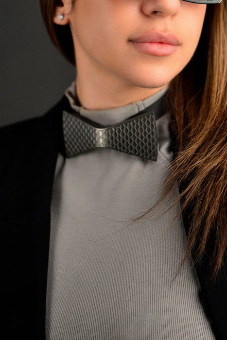 Woman wearing unities bow tie with a dark background