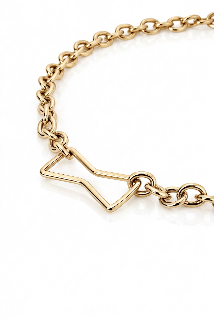 A close-up of a silver-toned metal chain bracelet with a geometric open-link charm, set against a clean white background.