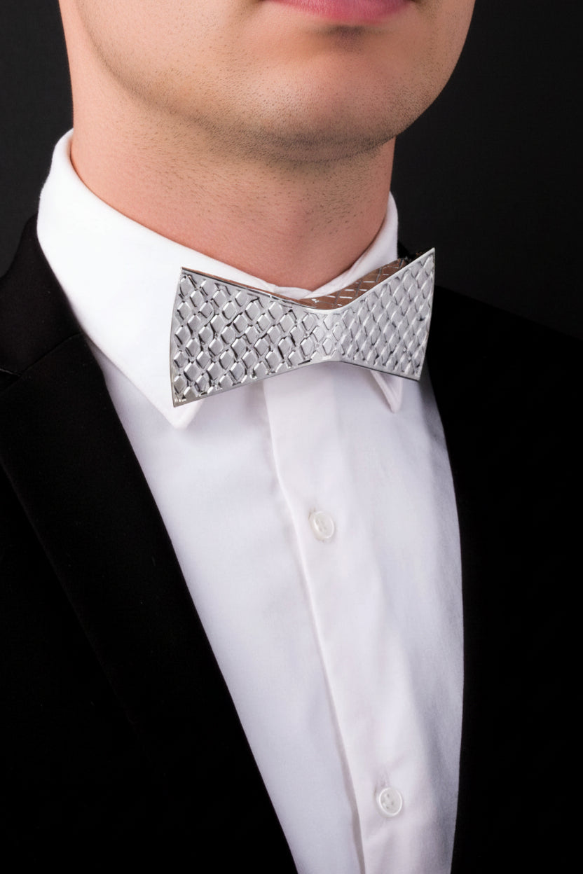 White shirt with a silver bow tie against a black background